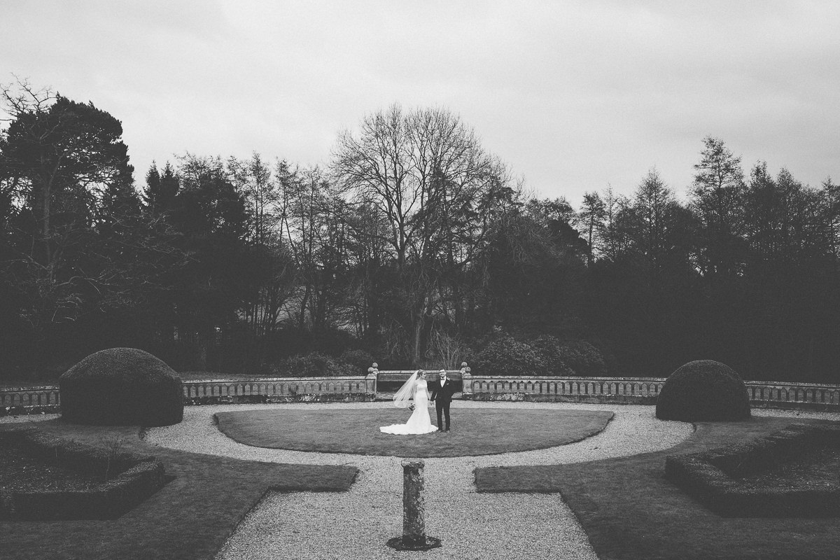 bride and groom in the gardens at Wroxall Abbey