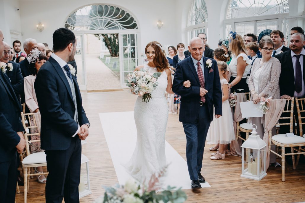 bride walks down the aisle at Barton Hall orangery - real wedding